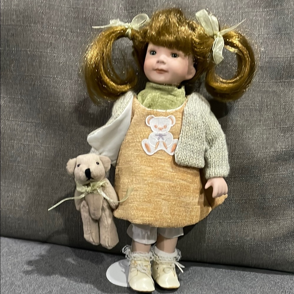 Duck House Heirloom Porcelain Doll with Yellow Teddy Dress holding TeddyBear